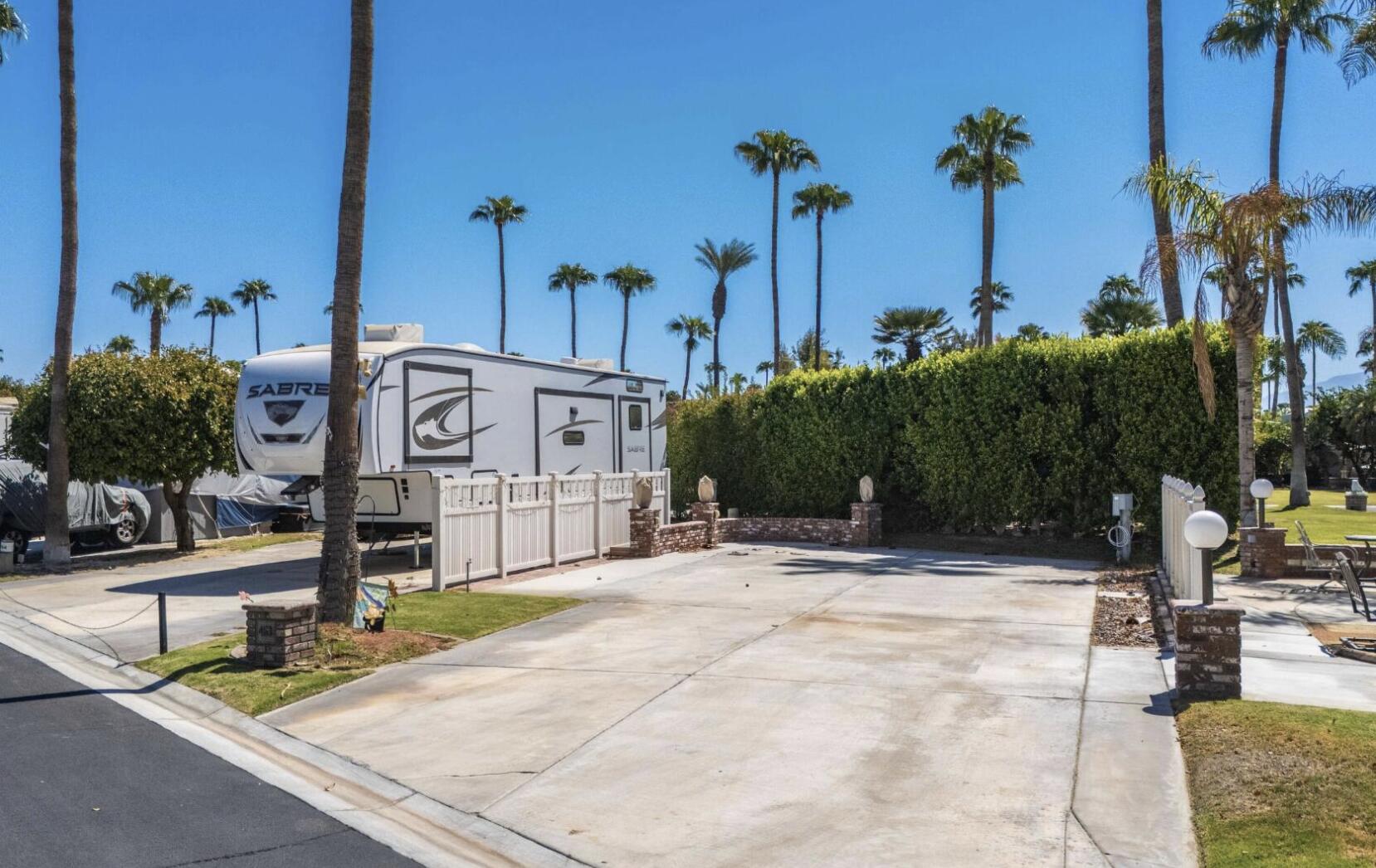 a view of a street with palm trees