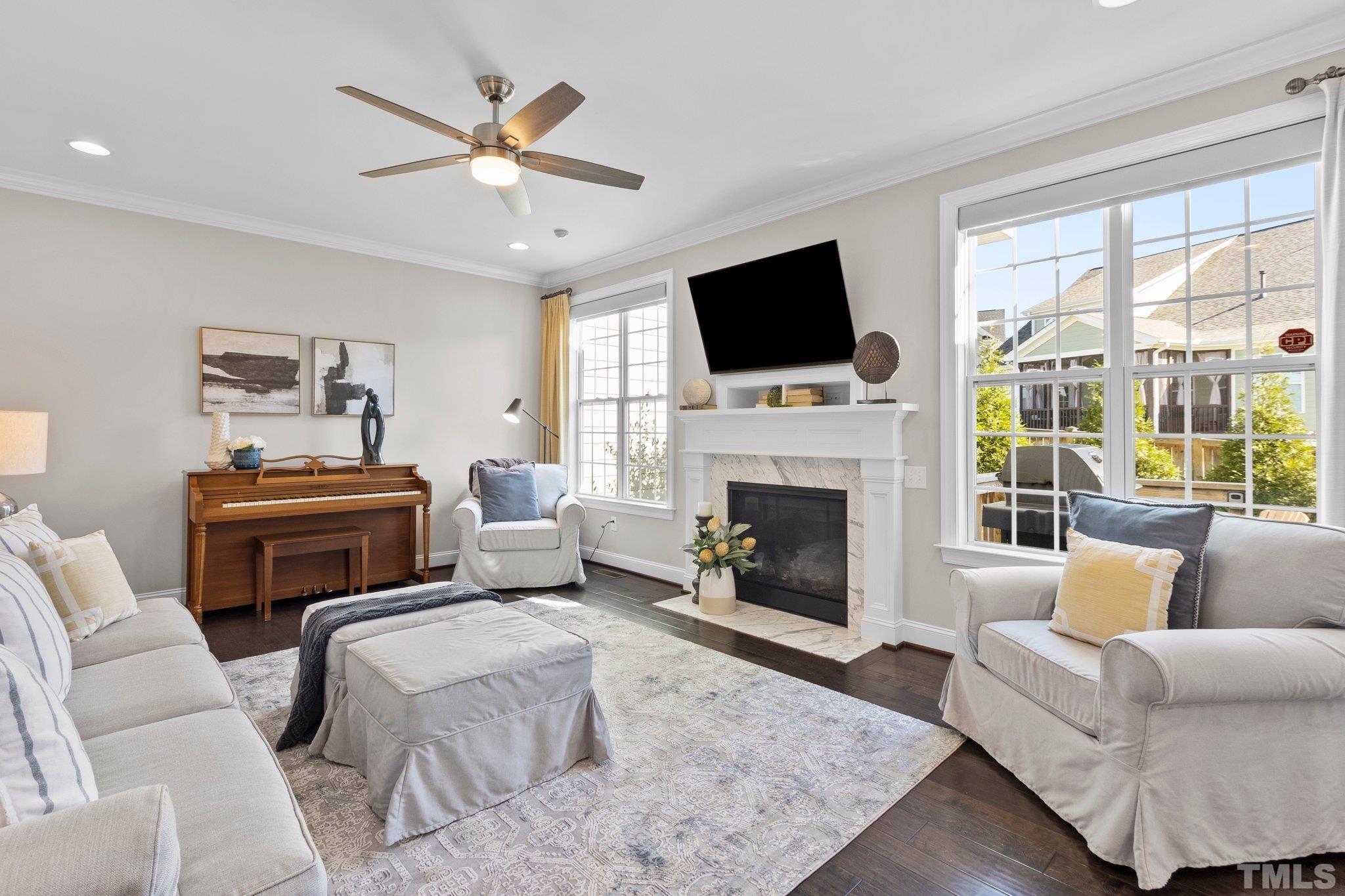 2830 Riley's Pond Drive Apex, NC 27502 - Photo 12 of 54 a living room with furniture a fireplace and a flat screen tv