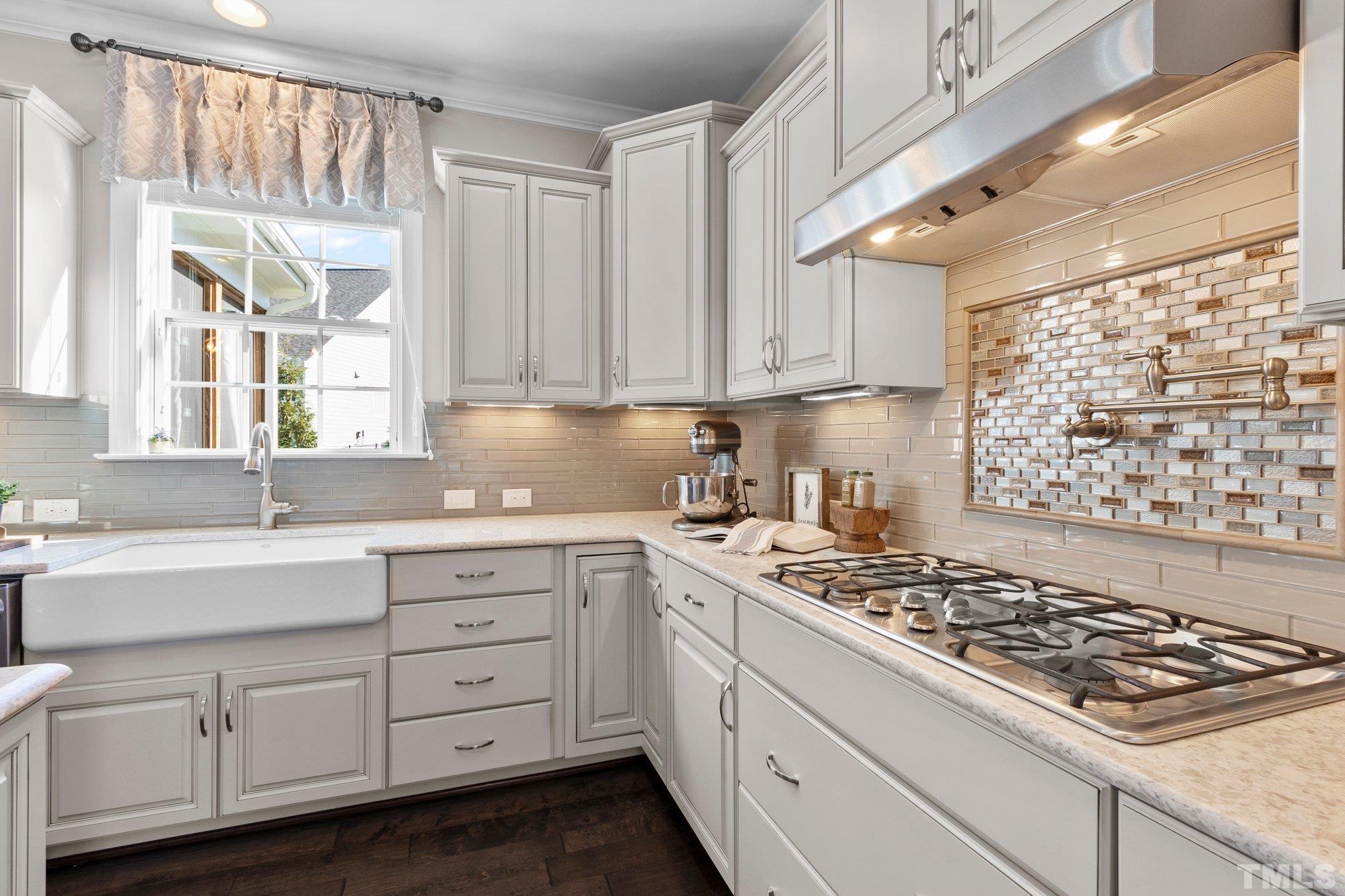 2830 Riley's Pond Drive Apex, NC 27502 - Photo 15 of 54 a kitchen with white cabinets and appliances