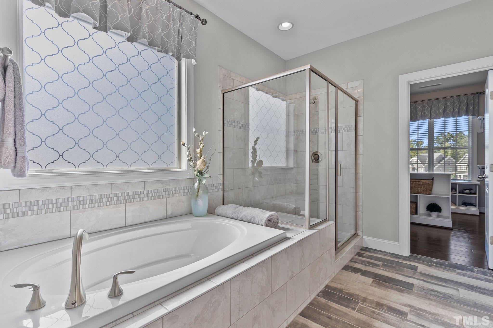 2830 Riley's Pond Drive Apex, NC 27502 - Photo 23 of 54 a bathroom with a bathtub and a shower