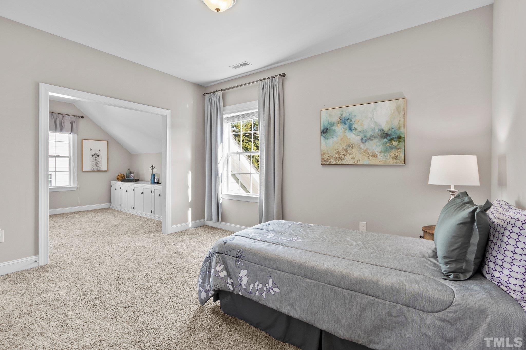 2830 Riley's Pond Drive Apex, NC 27502 - Photo 25 of 54 a bedroom with a bed and a painting on the wall