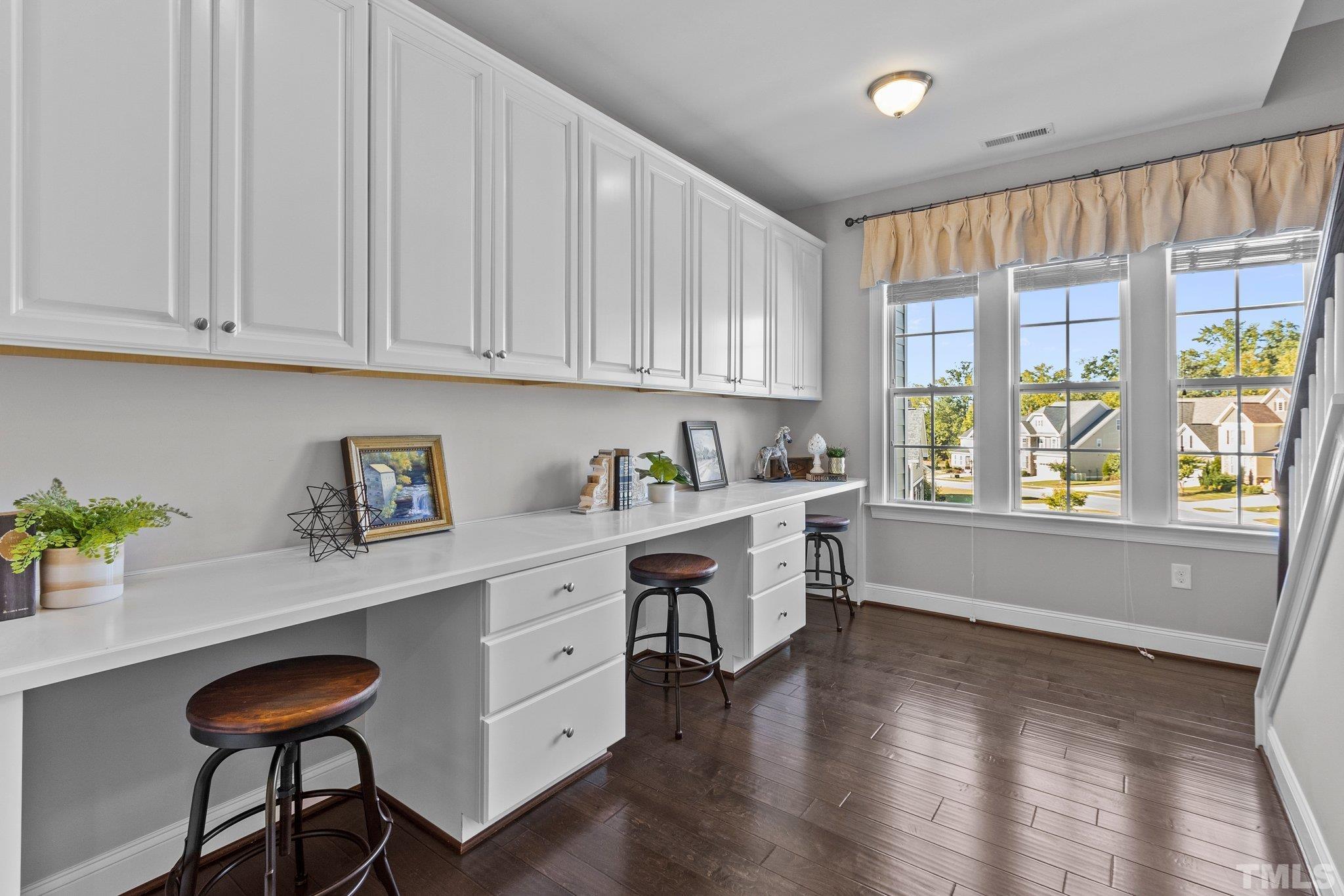 2830 Riley's Pond Drive Apex, NC 27502 - Photo 30 of 54 a kitchen with stainless steel appliances granite countertop a stove a sink dishwasher and a refrigerator with wooden floor