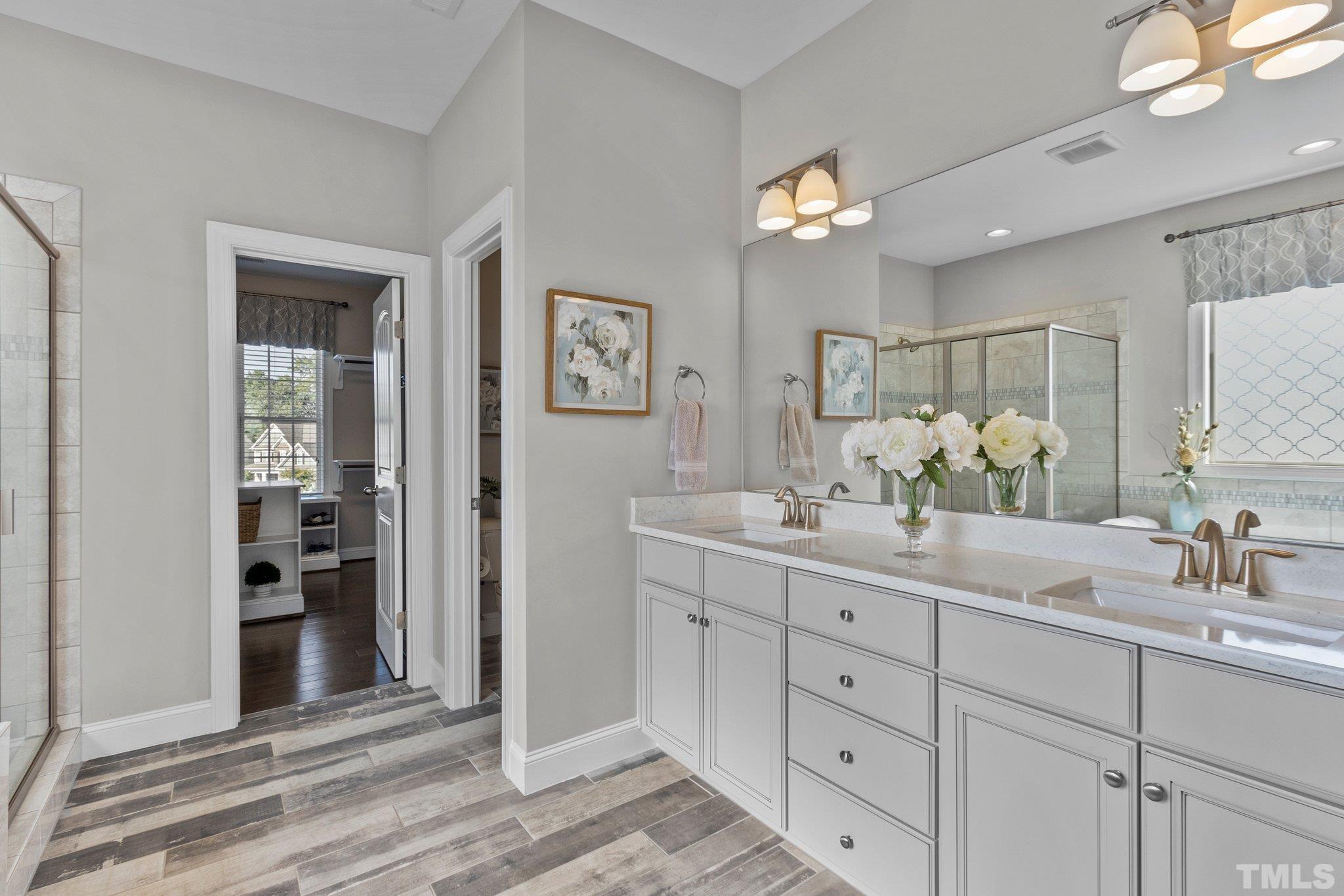 2830 Riley's Pond Drive Apex, NC 27502 - Photo 31 of 54 a bathroom with a double vanity sink and a mirror