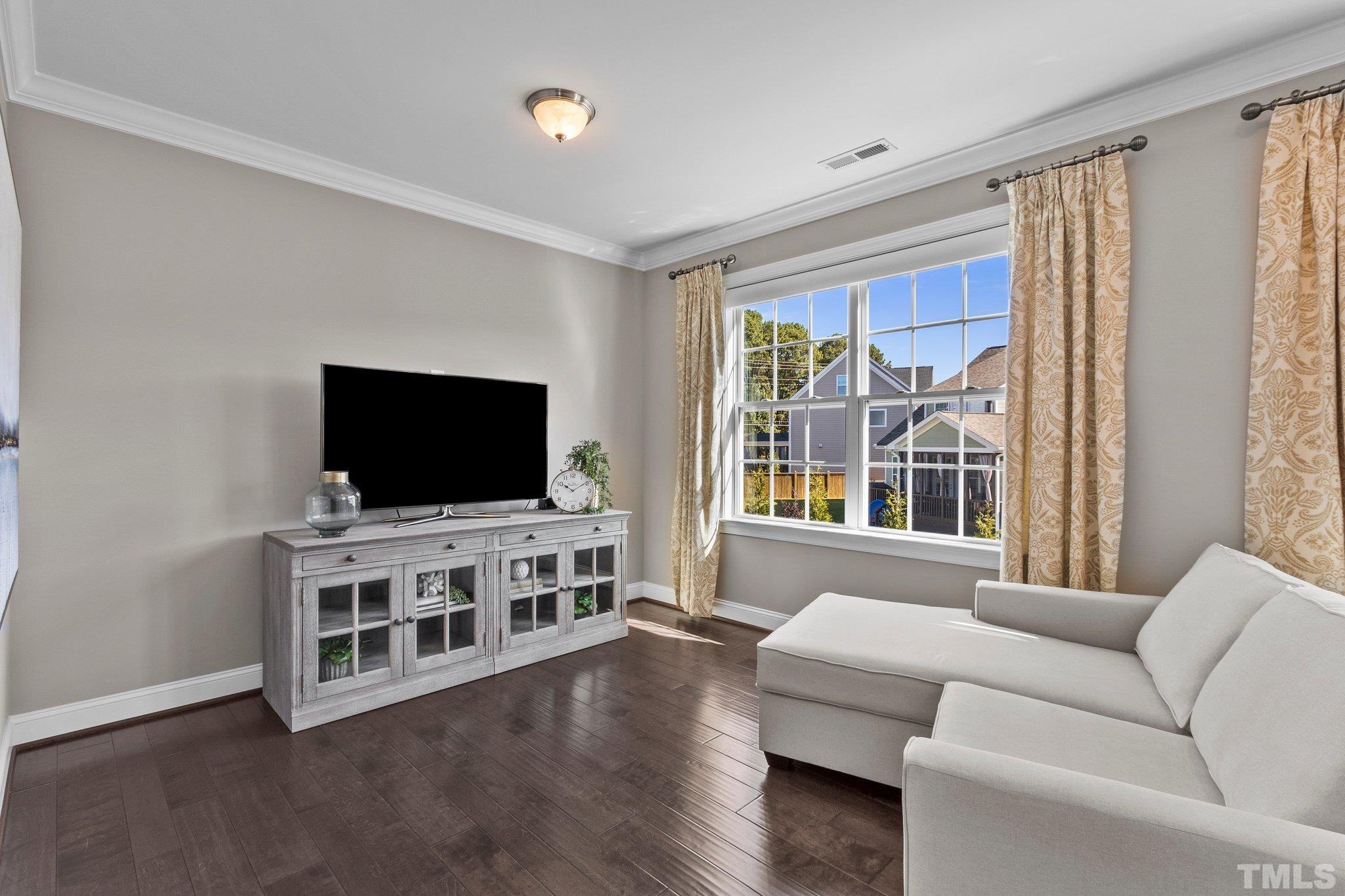 2830 Riley's Pond Drive Apex, NC 27502 - Photo 38 of 54 a living room with furniture and a flat screen tv