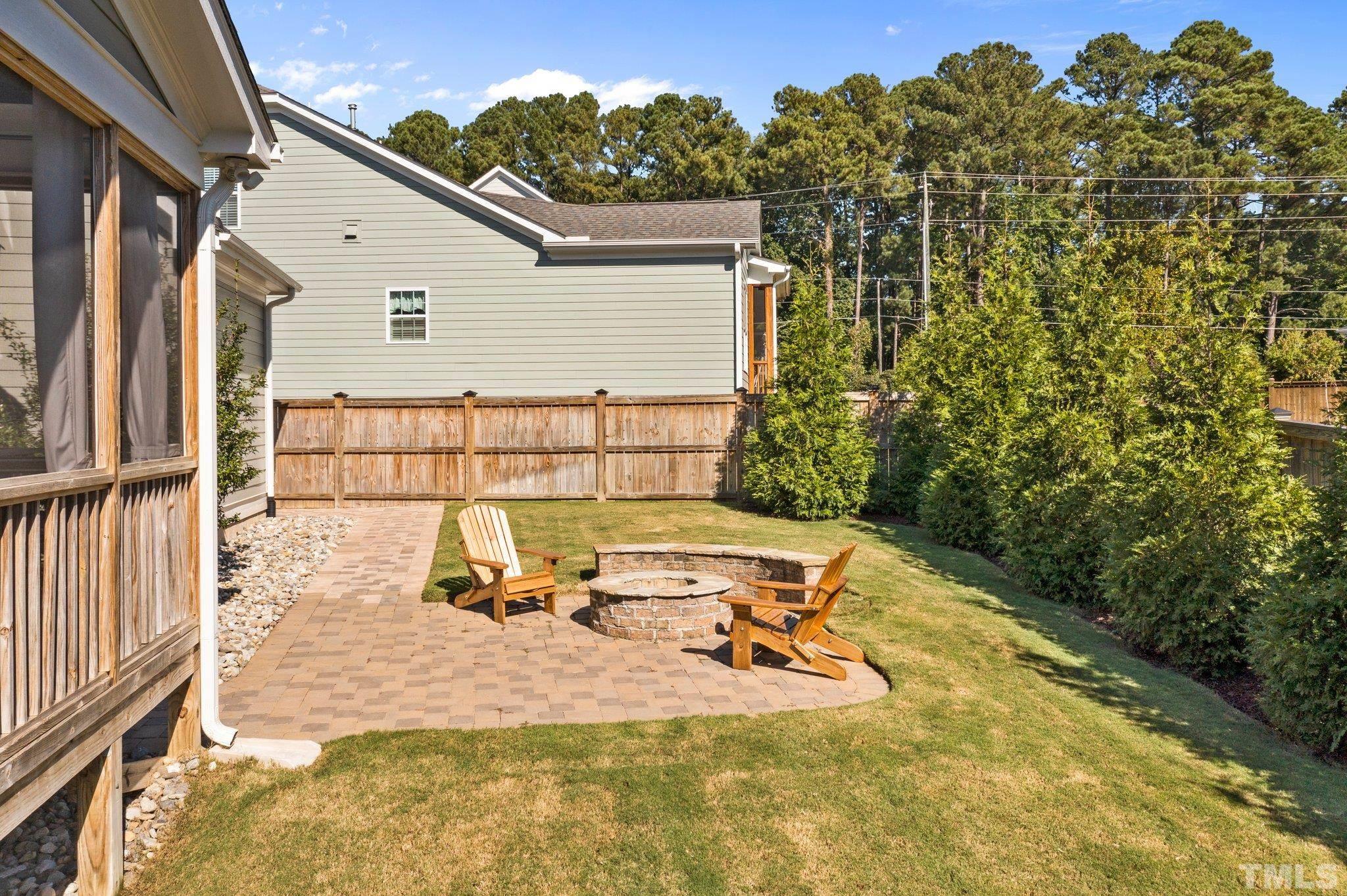 2830 Riley's Pond Drive Apex, NC 27502 - Photo 45 of 54 a view of a patio with table and chairs with wooden fence