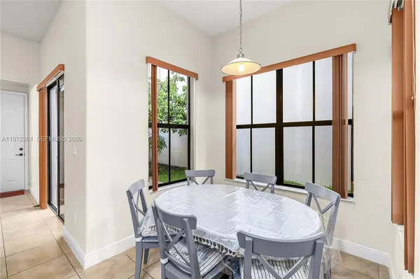 a view of a dining room with furniture and window