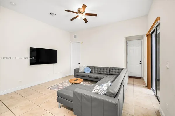 a living room with furniture and a flat screen tv