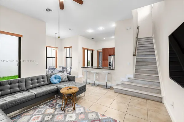 a living room with furniture and wooden floor