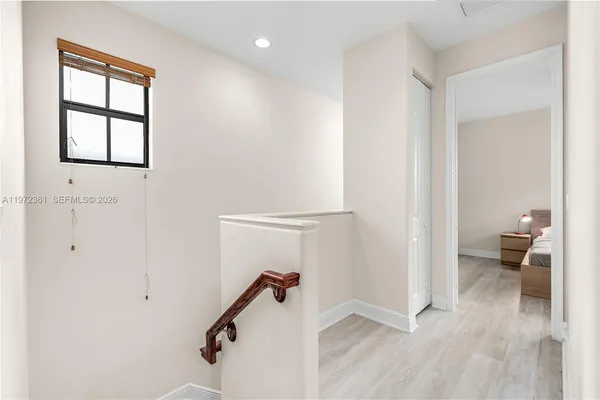a view of a room with wooden floor and windows