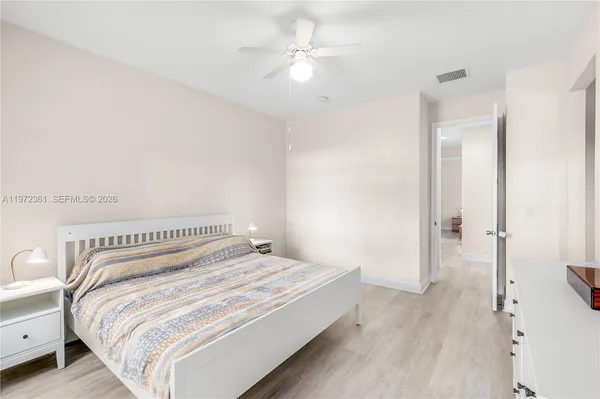a bedroom with a bed and a ceiling fan