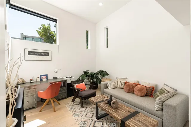 a living room with furniture and a floor to ceiling window