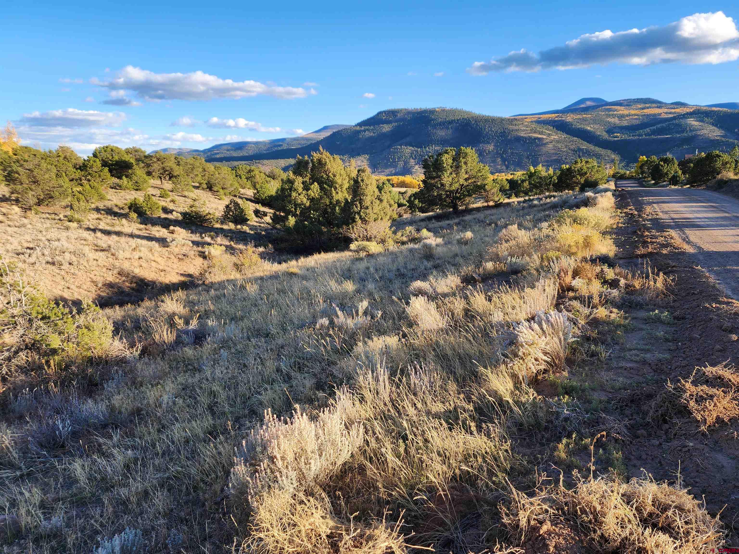 512 Kit Carson Road South Fork, CO 81154 - Photo 2 of 7 a view of a lake with mountains in the background