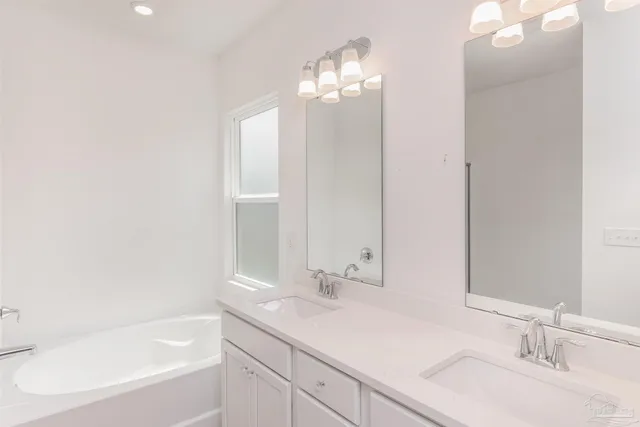 a bathroom with a bathtub a sink and a mirror