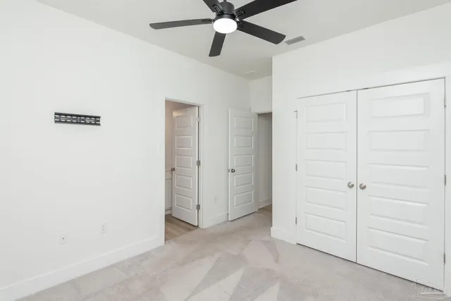 an empty room with a ceiling fan
