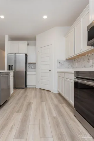 a kitchen with a sink cabinets and stainless steel appliances