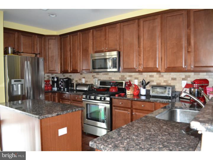 474 Aura Road Mullica Hill, NJ 08062 - Photo 11 of 21 a kitchen with stainless steel appliances granite countertop a sink refrigerator and microwave