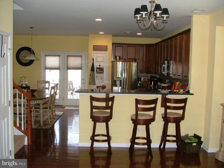 474 Aura Road Mullica Hill, NJ 08062 - Photo 13 of 21 a view of a dining room with furniture window and wooden floor
