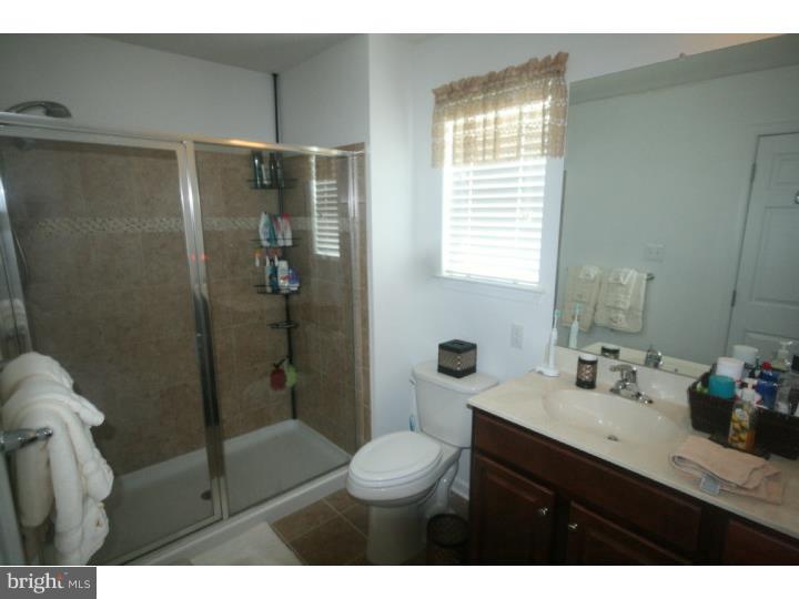 474 Aura Road Mullica Hill, NJ 08062 - Photo 16 of 21 a bathroom with a shower sink vanity mirror and toilet