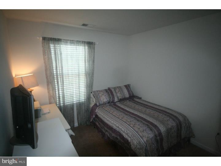 474 Aura Road Mullica Hill, NJ 08062 - Photo 17 of 21 a bedroom with a bed and a lamp
