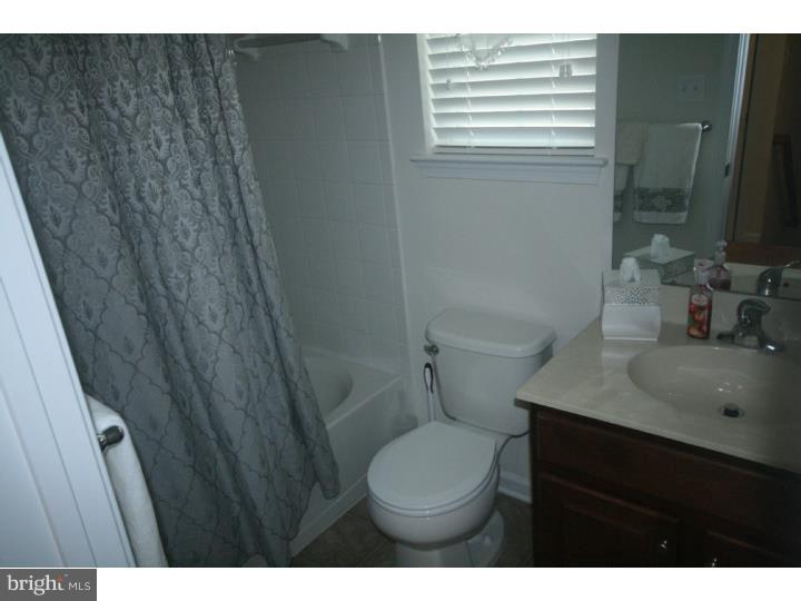 474 Aura Road Mullica Hill, NJ 08062 - Photo 19 of 21 a bathroom with a sink a toilet a mirror and vanity