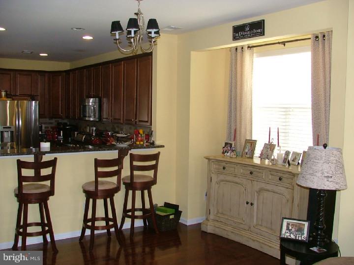 474 Aura Road Mullica Hill, NJ 08062 - Photo 8 of 21 a kitchen with a table chairs refrigerator and cabinets