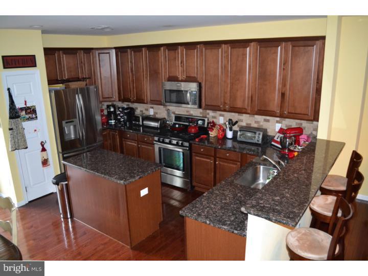 474 Aura Road Mullica Hill, NJ 08062 - Photo 9 of 21 a kitchen with stainless steel appliances granite countertop a stove refrigerator sink and cabinets