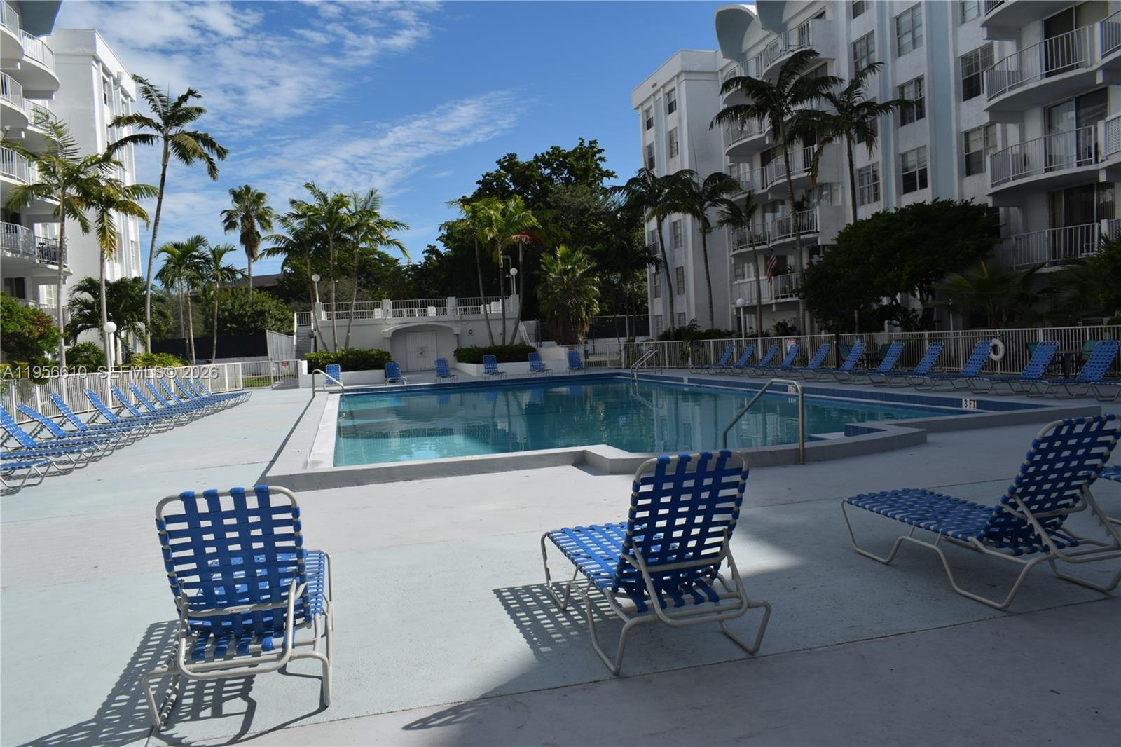 486 Northwest 165th Street, Unit B501 Miami, FL 33169 - Photo 12 of 14 a patio with table and chairs