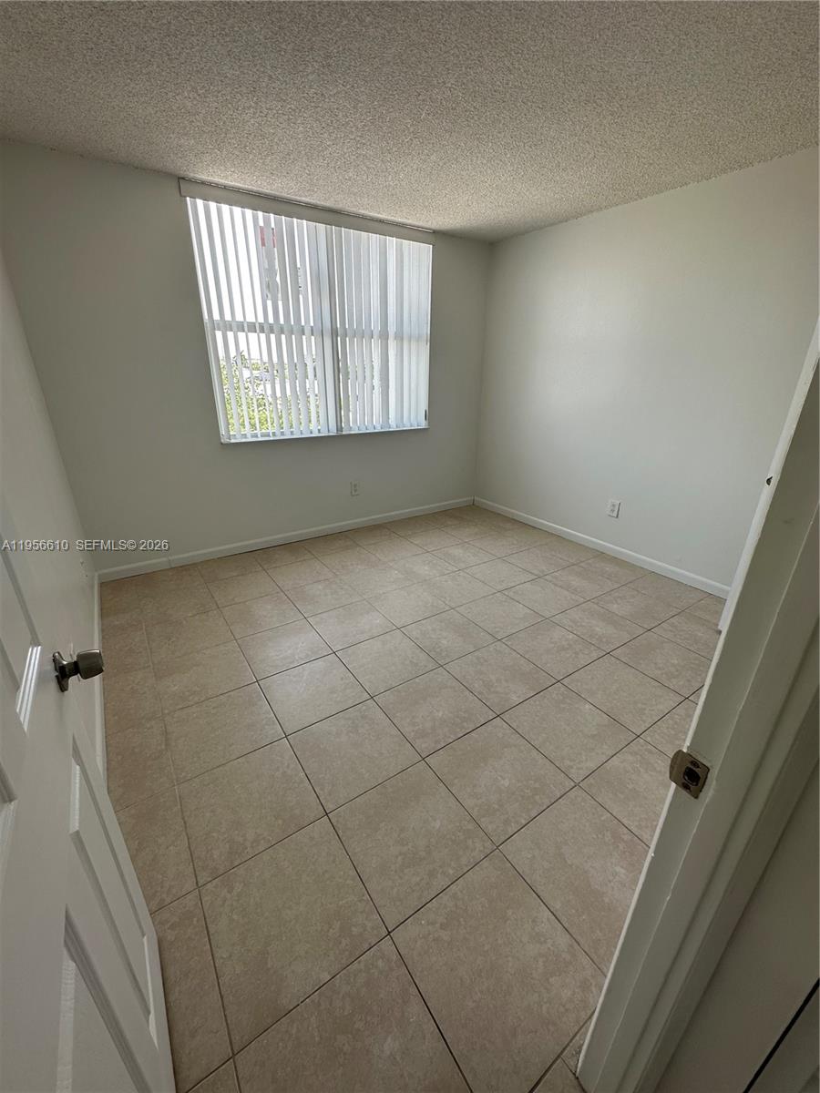 486 Northwest 165th Street, Unit B501 Miami, FL 33169 - Photo 6 of 14 a view of an empty room with a window