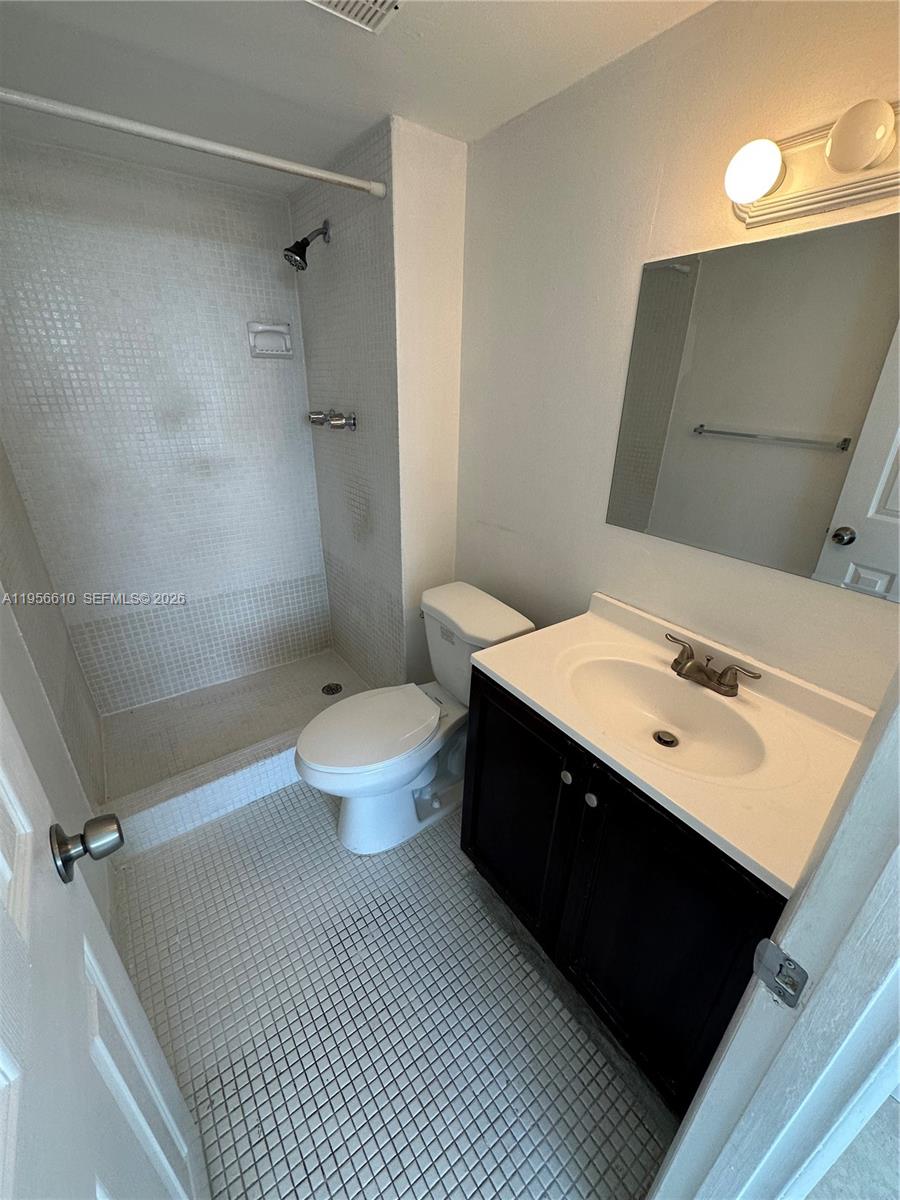 486 Northwest 165th Street, Unit B501 Miami, FL 33169 - Photo 7 of 14 a bathroom with a sink toilet and shower