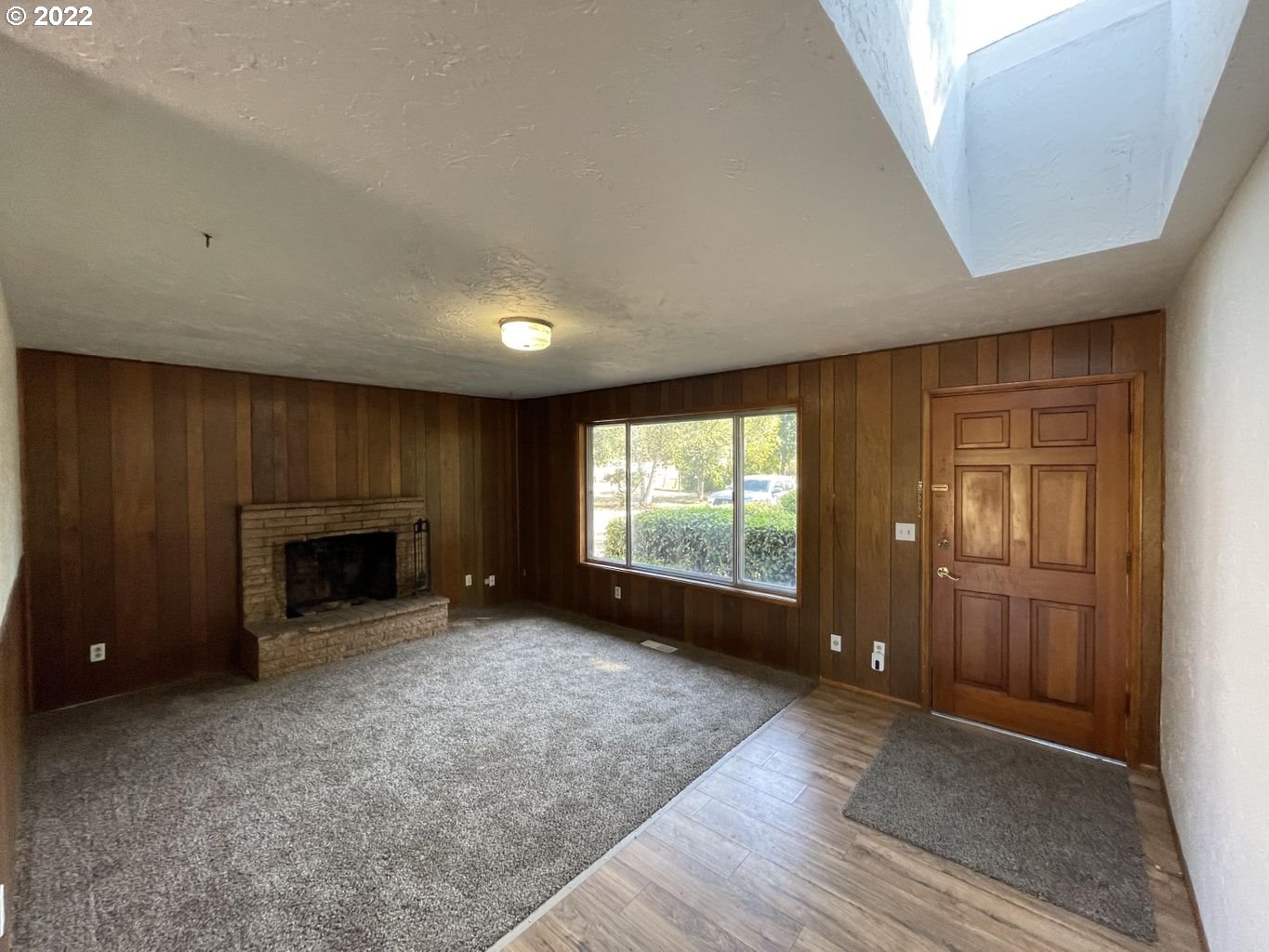 5970 Brickyard Road Tillamook, OR 97141 - Photo 4 of 32 an empty room with windows and fireplace