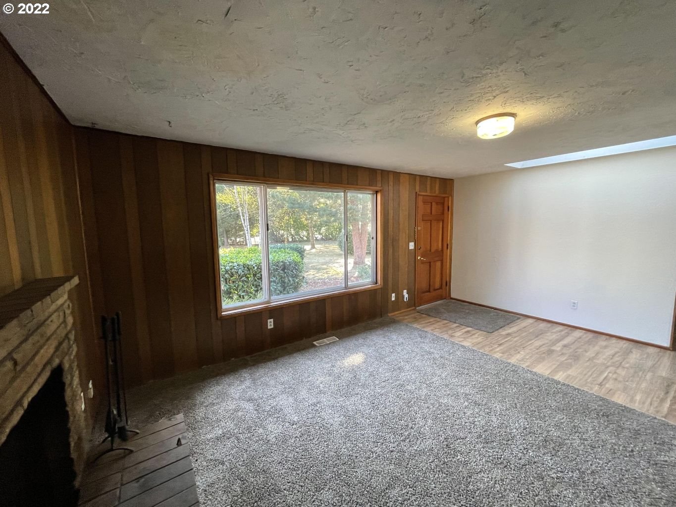 5970 Brickyard Road Tillamook, OR 97141 - Photo 5 of 32 a view of an empty room with a fireplace and a window