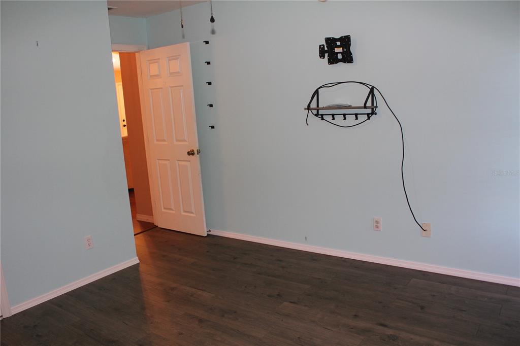 7238 Evergreen Loop Polk City, FL 33868 - Photo 16 of 28 a view of an entryway with wooden floor