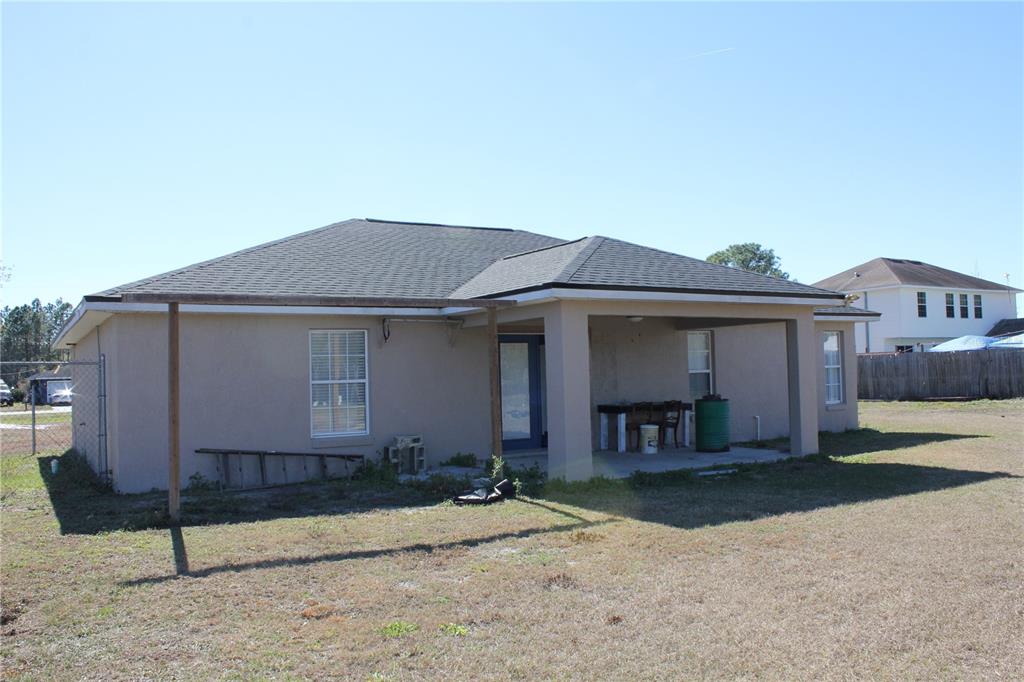 7238 Evergreen Loop Polk City, FL 33868 - Photo 24 of 28 a front view of a house with garden