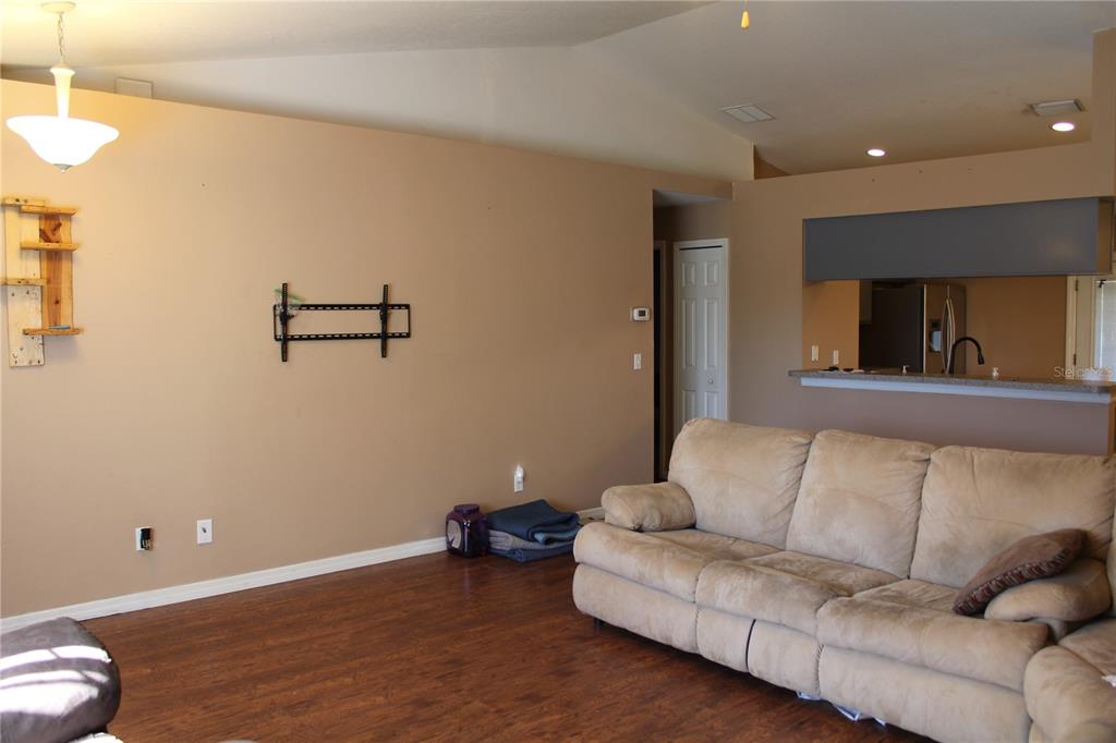 7238 Evergreen Loop Polk City, FL 33868 - Photo 4 of 28 a living room with furniture and a wooden floor