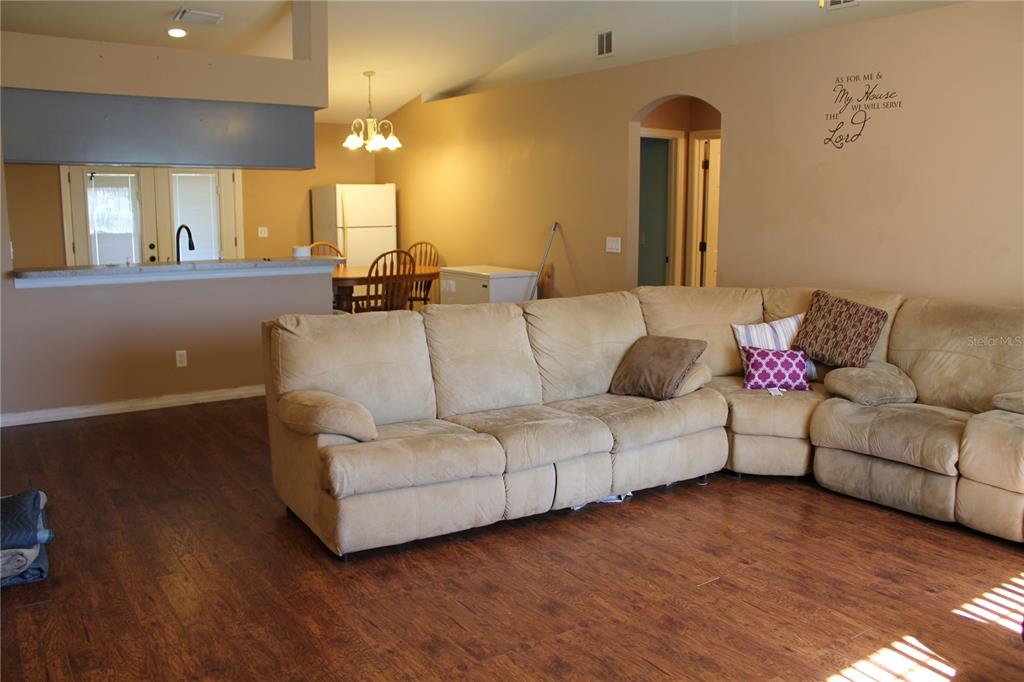 7238 Evergreen Loop Polk City, FL 33868 - Photo 6 of 28 a living room with furniture and a wooden floor
