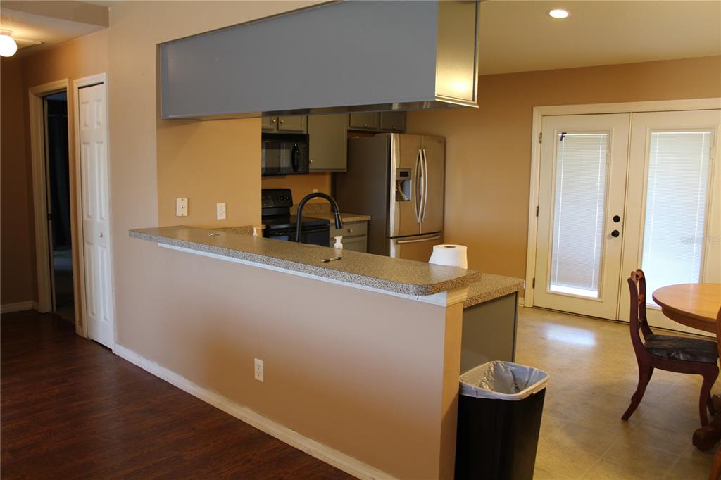 7238 Evergreen Loop Polk City, FL 33868 - Photo 7 of 28 a kitchen with sink refrigerator and microwave