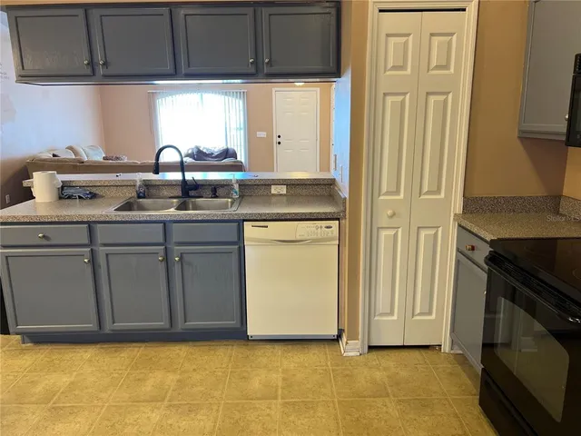a kitchen with a sink cabinets and a window