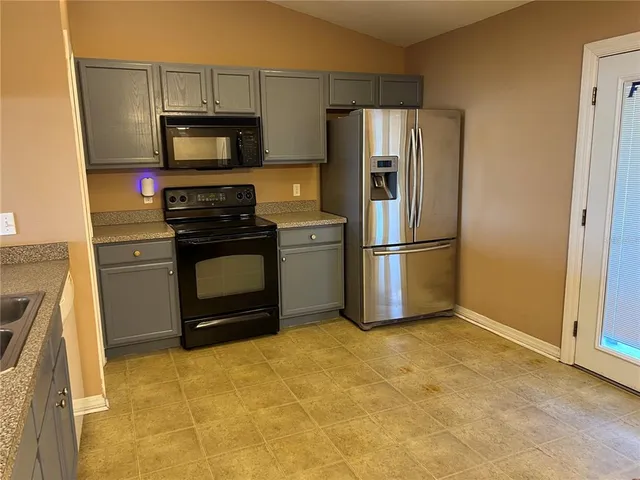 a kitchen with a refrigerator stove and microwave