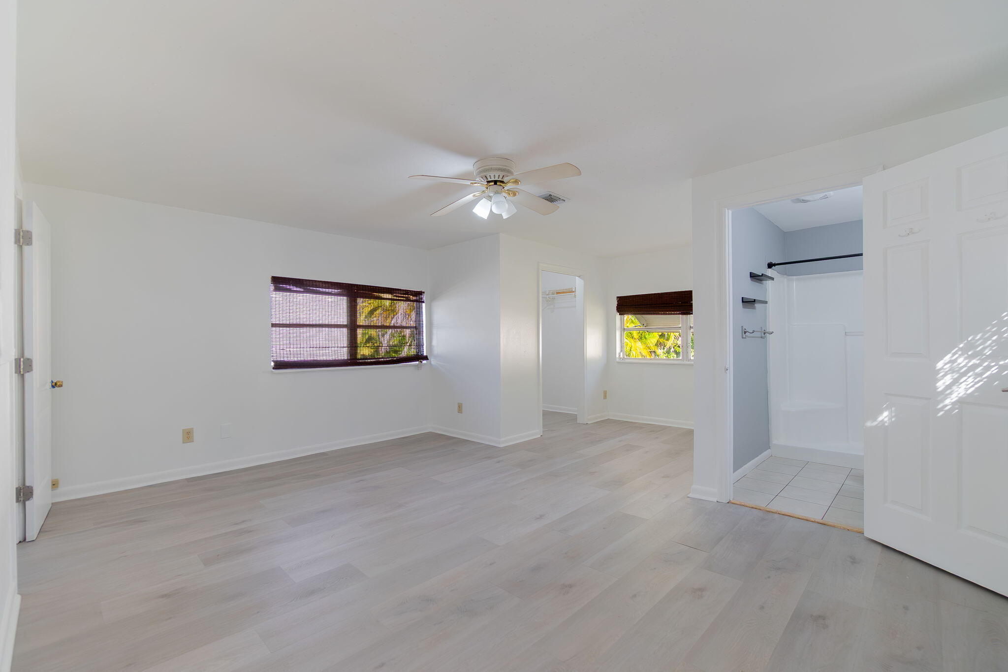 5519 Southeast Normandy Avenue Stuart, FL 34997 - Photo 20 of 38 an empty room with windows and ceiling fan