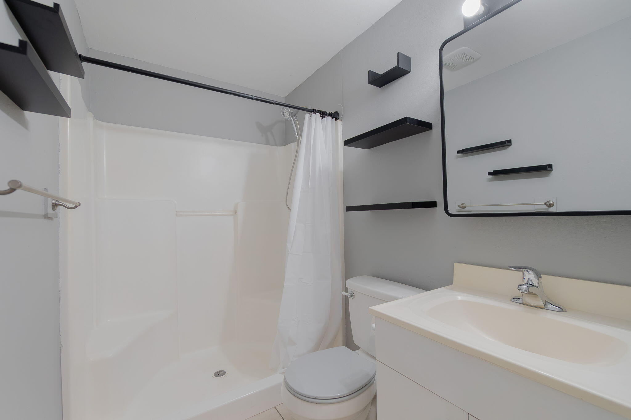 5519 Southeast Normandy Avenue Stuart, FL 34997 - Photo 24 of 38 a bathroom with a sink toilet and shower