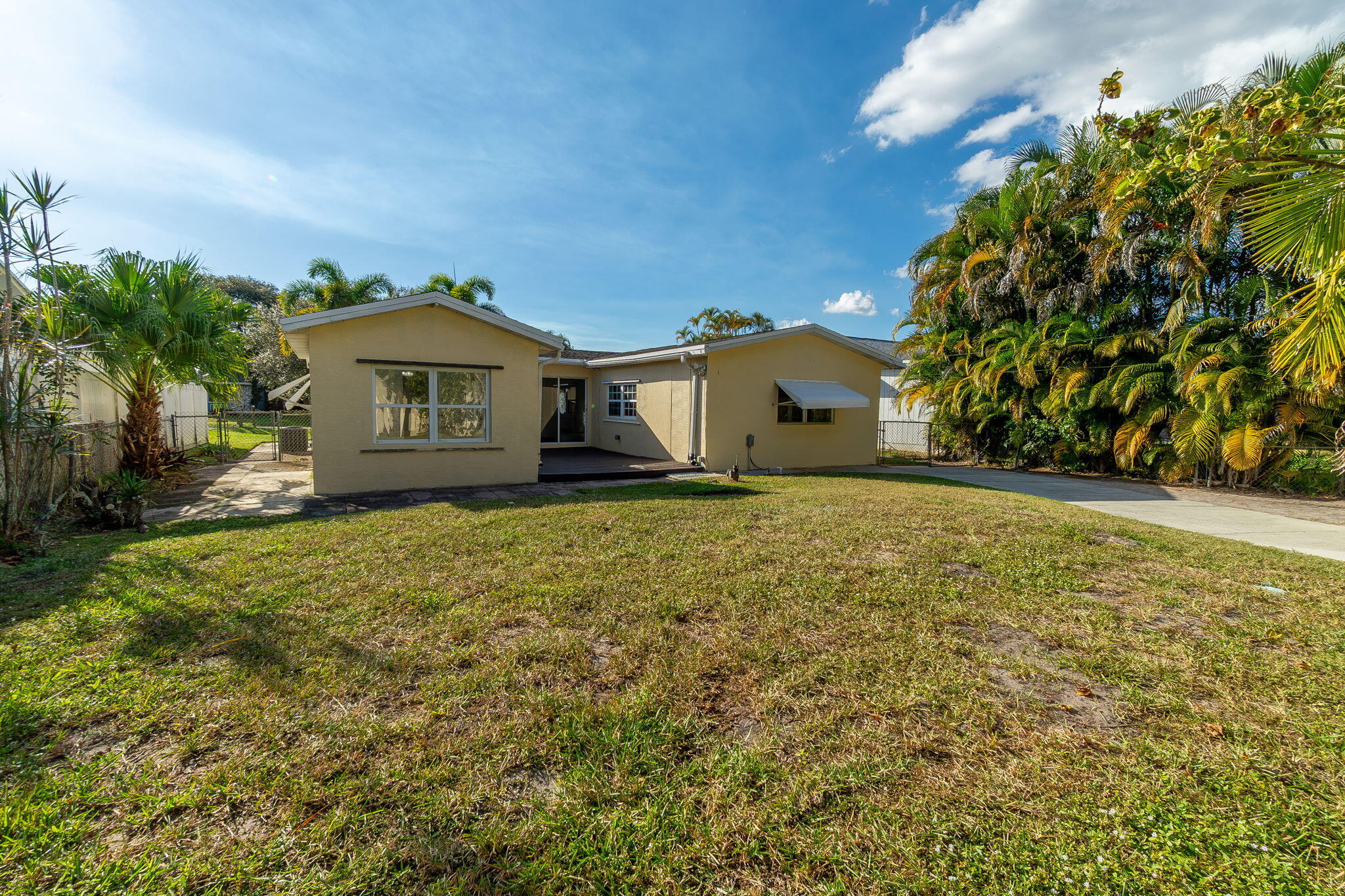 5519 Southeast Normandy Avenue Stuart, FL 34997 - Photo 29 of 38 a front view of a house with a yard