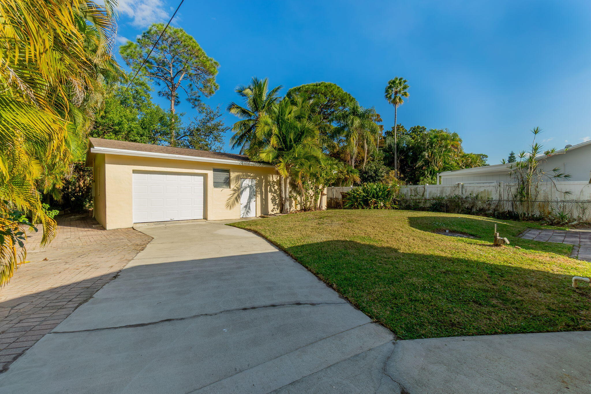 5519 Southeast Normandy Avenue Stuart, FL 34997 - Photo 32 of 38 a front view of a house with garden