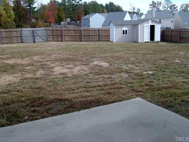 5900 Roteny Court Raleigh, NC 27610 - Photo 5 of 6 large fenced-in yard with patio, deck, and storage shed