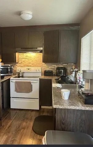 a kitchen with a stove a sink and a microwave
