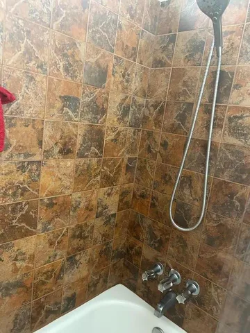 a bathroom with a toilet and a shower