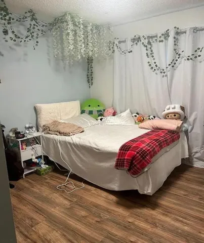 a spacious bedroom with a bed and a table in it