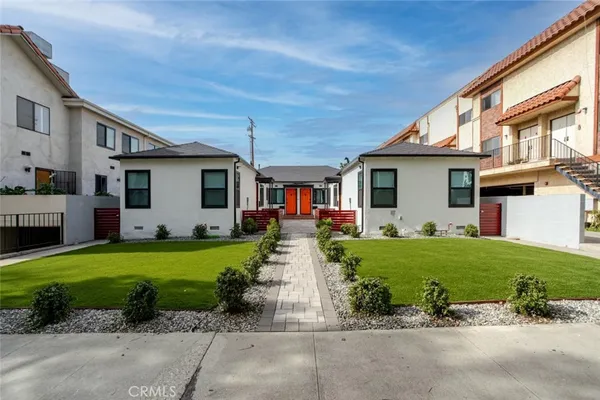 a front view of a house with a garden and porch