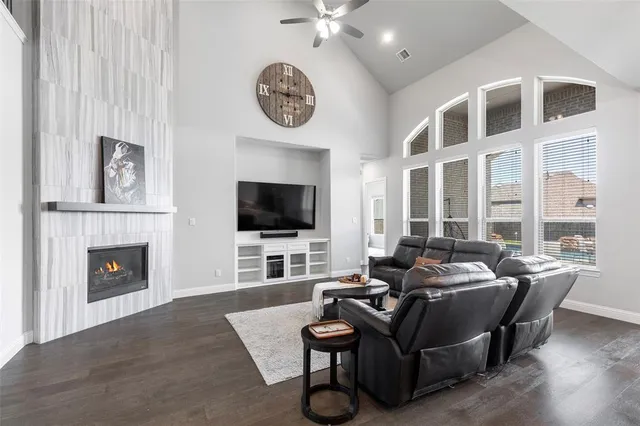 a living room with furniture a flat screen tv and a fireplace