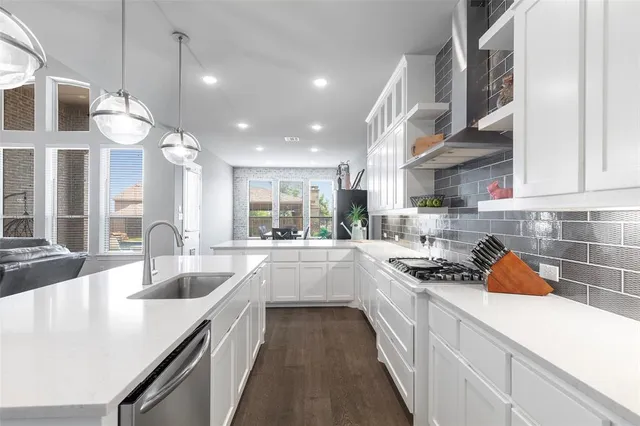a kitchen with a sink stove and cabinets