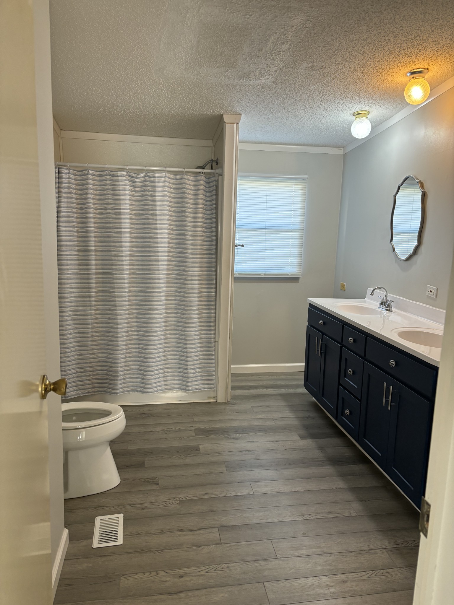 2475 Canoe Branch Road Lebanon, TN 37087 - Photo 23 of 25 a bathroom with a double vanity sink toilet and a mirror